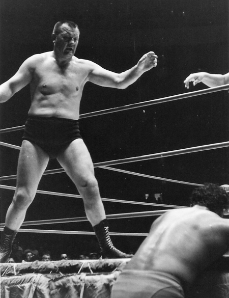 Gene Kiniski stands over Pedro Morales