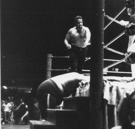 Iaukea goes after Monsoon outside the ring